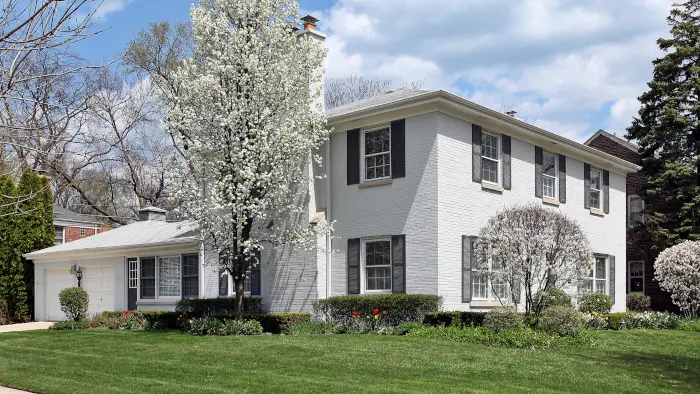 Mandatory obligations - White brick home in spring.